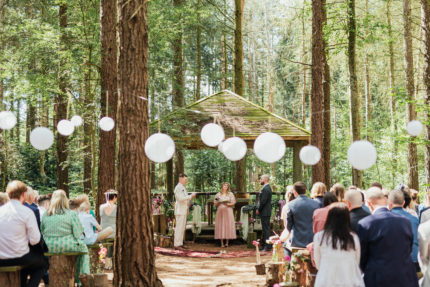 Same sex couple exchange vows at outdoor wedding at Camp Katur